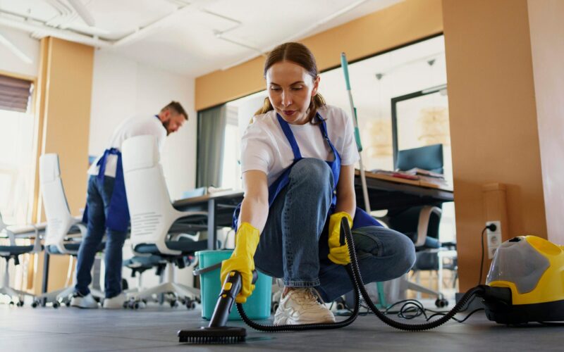 carpet cleaning 4 - shorter female cleaning the workplace carpet